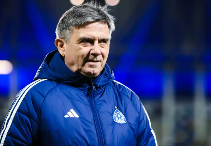 Doświadczony trener Ruchu Chorzów w niebieskiej kurtce z herbem klubu.