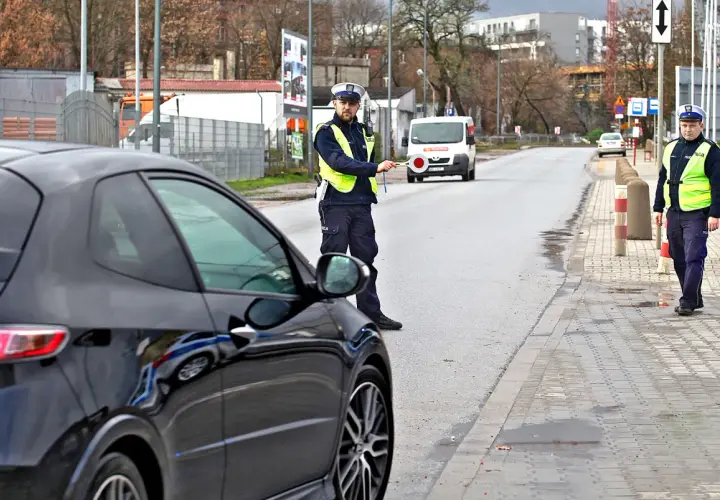 Policjant zatrzymuje czarne auto. Czyżby to recydywa mandat za prędkość?