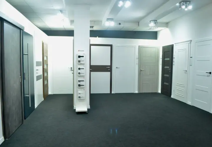 Salon z drzwiami i klamkami, prezentujący różne modele drzwi wewnętrznych i zewnętrznych.