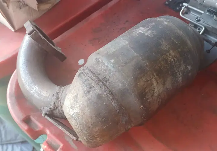 Stary, skorodowany katalizator samochodowy. Zapchany DPF objawy mogą być podobne, gdy filtr cząstek stałych jest zatkany.