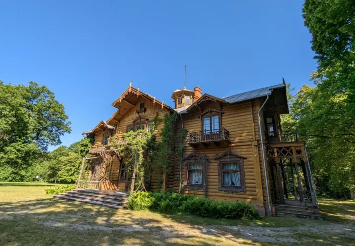 Drewniany dworek z bogatymi zdobieniami, otoczony zielenią. Jedna z leżajskich atrakcji, która zachwyca architekturą.