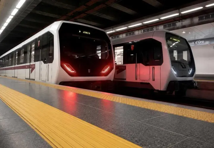 Due treni moderni fermi in banchina alla metropolitana Laurentina, pronti a partire.