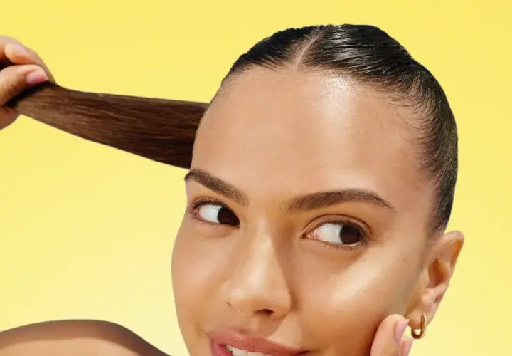 Mujer con cabello oscuro y liso, mostrando su brillo. ¡La vitamina C para el pelo es clave para un cabello radiante y saludable!