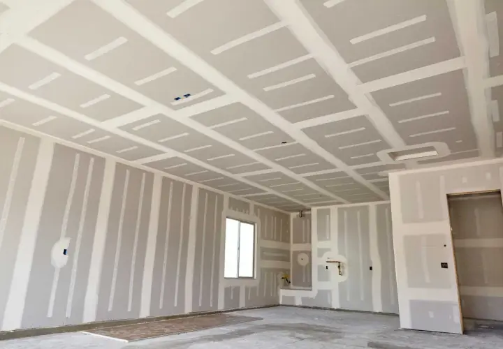 Interno di un locale in costruzione con pareti e soffitto in cartongesso, in attesa del passaggio degli impianti.