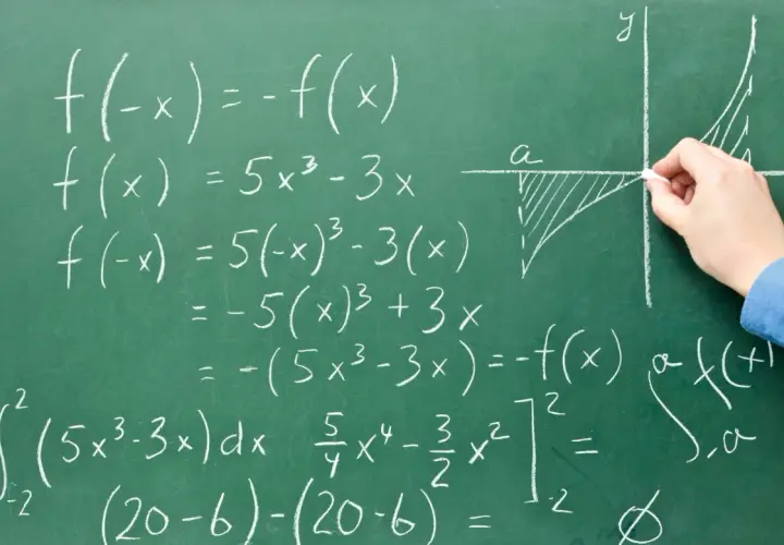 Rysunek na tablicy pokazuje obliczenia matematyczne, w tym całki i funkcje, ilustrujące, co to system zero jedynkowy a binarny.