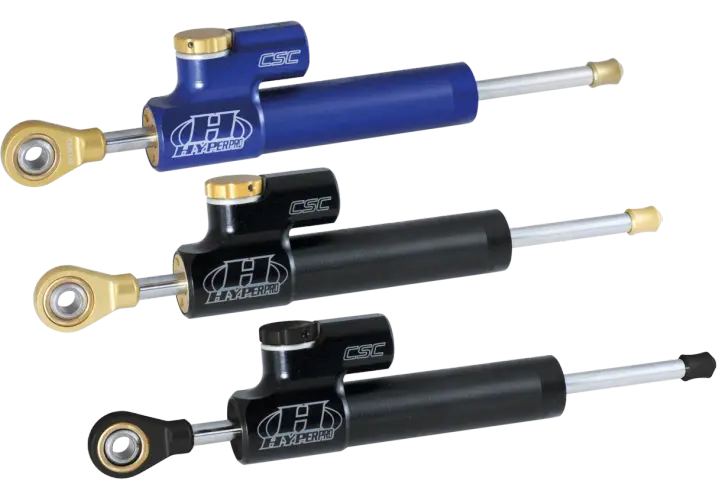 Tre ammortizzatori Hyperpro CSC, uno blu e due neri, perfetti per migliorare la stabilità delle Harley Davidson.