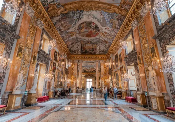 Intérieur somptueux du palais Colonna, avec fresques au plafond, statues, lustres en cristal et marbre au sol.