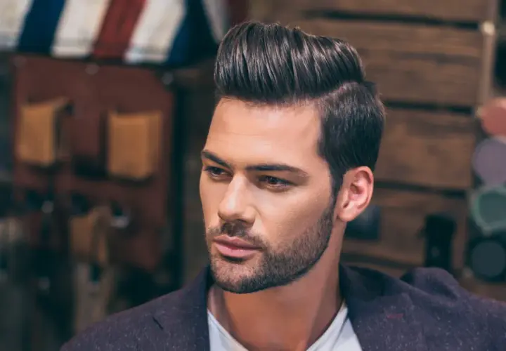 Hombre con peinado moderno y raya del pelo marcada a la derecha.