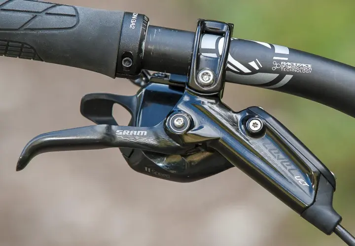 Close-up of a SRAM Level Ultimate brake lever on a mountain bike handlebar, ready for any trail.