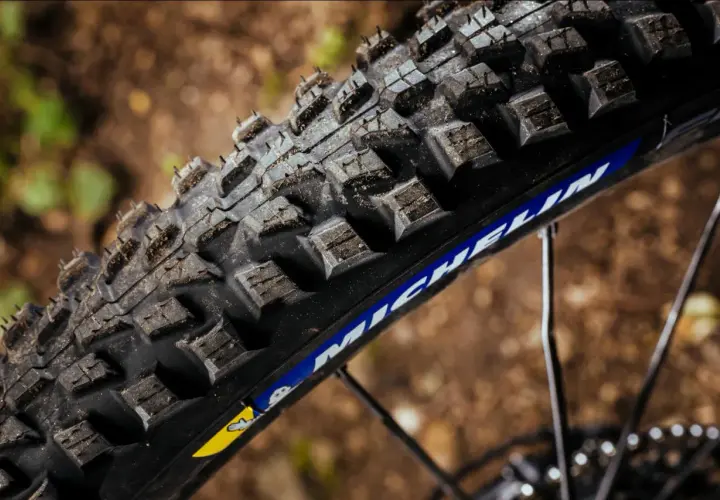 Close-up of a rugged Michelin Force AM2 tire, ready to grip the trail.