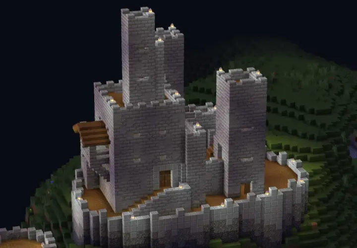 Potężny kamienny zamek z wieżami, dziedzińcem i schodami. To pokazuje, co można zbudować w Minecraft.