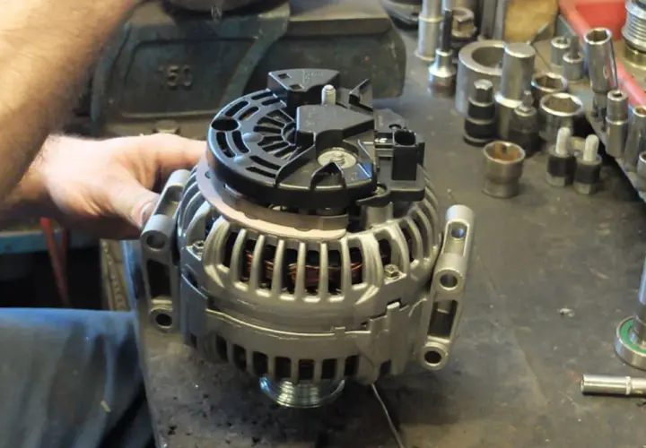 Mechanik pracuje nad regeneracją alternatora. Sprawdź, jaka jest regeneracja alternatora cena i przywróć sprawność pojazdu.