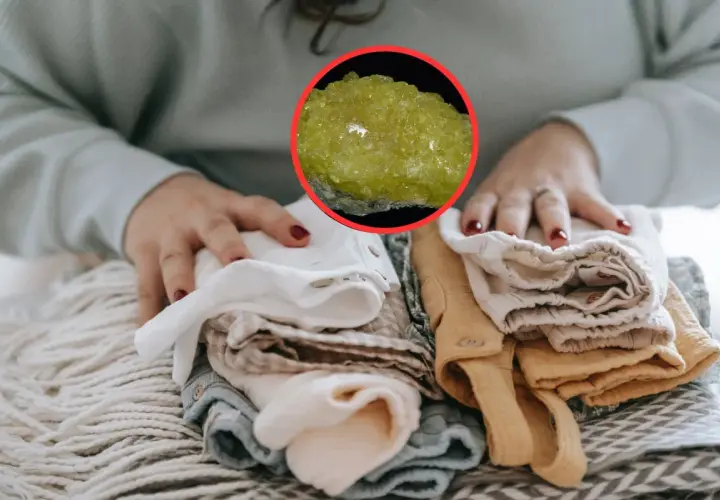 Manos doblando ropa limpia, con una piedra amarilla brillante que evoca el olor a mercaptano.