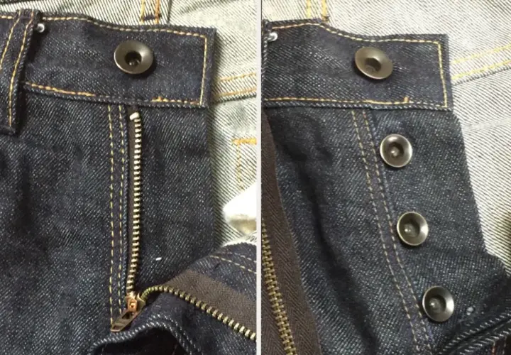 Close-up of dark wash jeans. One side shows a zipper fly with a single bouton jeans at the top. The other side displays three bouton jeans.