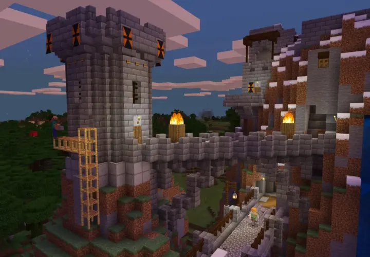 Kamienna twierdza w Minecraft, zbudowana na zboczu góry. Widać wieże, mosty, pochodnie i wodospad. Gra wymaga kreatywności!
