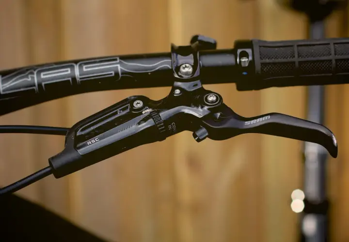 Close-up of a black SRAM Guide RSC brakes lever on a bicycle handlebar.