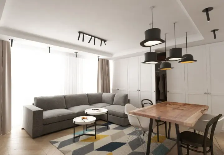 Nowoczesny salon z szarą kanapą, stolikami kawowymi i stołem z litego drewna. Inspiracja, jak umeblować salon, by był funkcjonalny i stylowy.