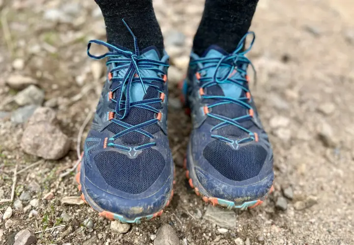 Close-up of a pair of La Sportiva Bushido III trail running shoes, laced up and ready for adventure on a rocky path.