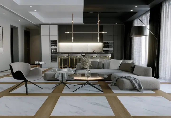 Soggiorno moderno con pavimenti interni che combinano marmo e legno, tra le ultime tendenze. Divano grigio, poltrona, tavolini e cucina a vista.