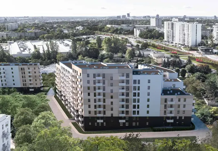 Nowoczesne bloki mieszkalne otoczone zielenią, w tle miejski krajobraz Poznania.