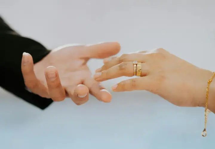 Manos entrelazadas, anillos de oro simbolizan una boda de oro, ¡cuántos años son 50 de amor y compromiso!