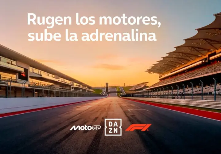 Pista de carreras al atardecer, con gradas y logos de MotoGP y DAZN. ¡Siente la adrenalina y descubre donde ver MotoGP!
