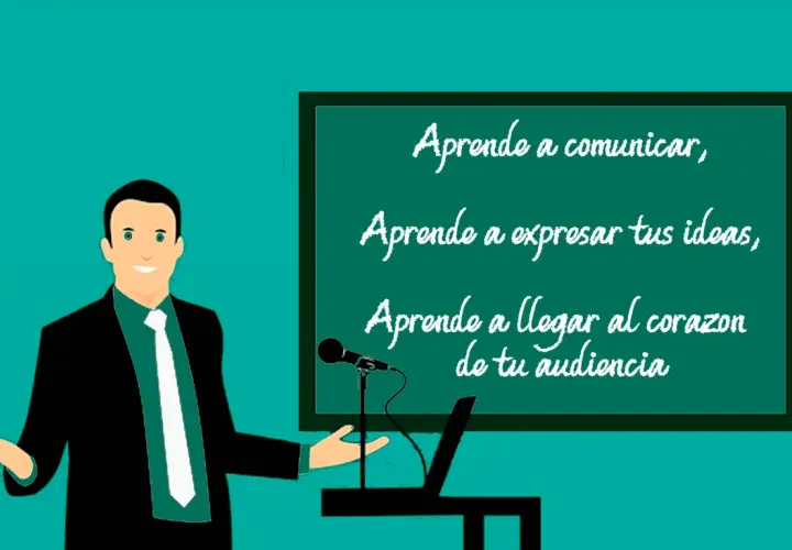 Un orador sonriente, con un traje negro y corbata blanca, presenta en una pizarra. La pizarra muestra un ejemplo de qué es una anáfora: "Aprende a comunicar, Aprende a expresar tus ideas, Aprende a llegar al corazón de tu audiencia".