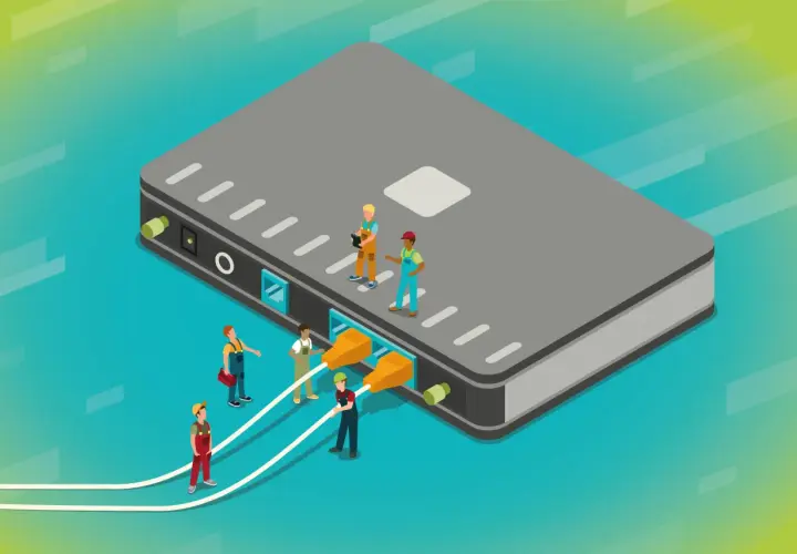 Des ouvriers connectent des câbles à un grand boîtier gris, illustrant a quoi sert un switch : relier plusieurs appareils pour un réseau.