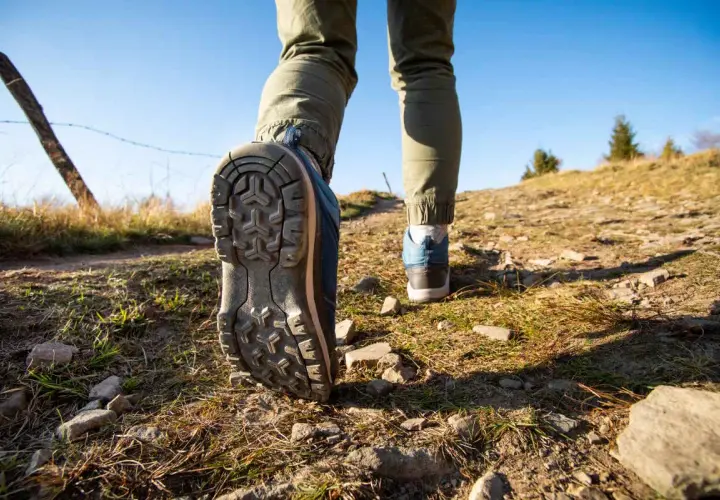 Dobre buty w Tatry to podstawa! Widok na szlak, gdzie stopy w solidnych trekkingowych butach stawiają kolejne kroki.