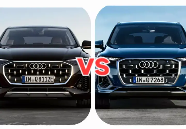 Dwa nowe Audi Q7 w zbliżeniu, czarne i granatowe, z napisem "VS" pośrodku.