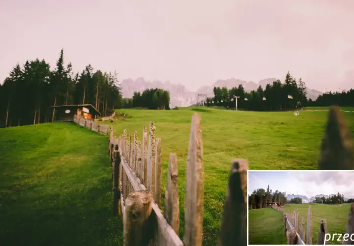 Darmowe presety Lightroom ożywiają krajobraz z drewnianym płotem i chatką w górach.