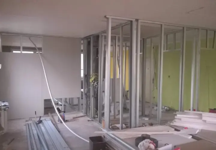 Costruzione di pareti in cartongesso, un materiale che, sebbene comune, è tossico e richiede attenzione durante la manipolazione.