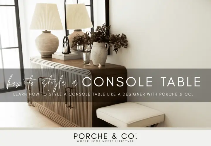 Learn how to style a console table with this designer guide. The image shows a beautifully styled console table with lamps, books, and a vase of flowers.