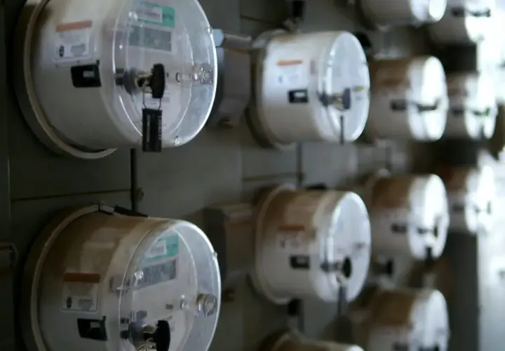 Rząd liczników energii elektrycznej, gotowych do odczytu. Dowiedz się, jak przepisać licznik Enea.