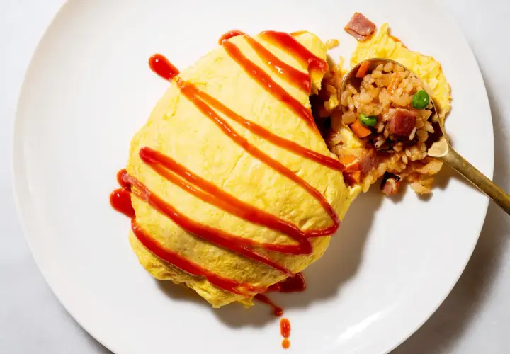 A delicious omurice, drizzled with ketchup. This dish is a popular choice for those curious about omurice calories, offering a satisfying meal.