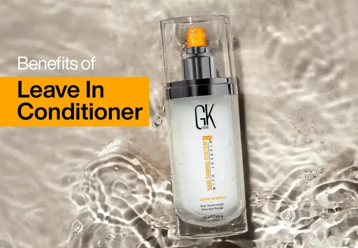 Un spray leave in para el cabello GK Hair, que promete beneficios para el pelo, descansa sobre una superficie con agua.