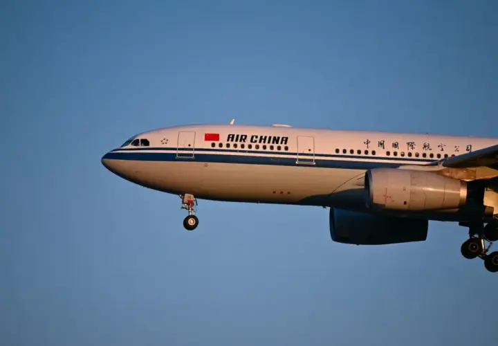 Samolot Air China z wysuniętym podwoziem, gotowy do lądowania. Wiele osób szuka pozytywnych air china opinie przed podróżą.
