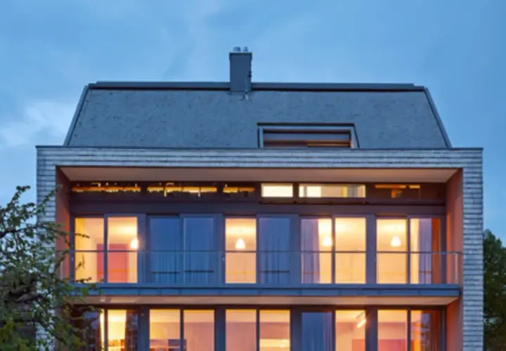 Modernes Haus mit großzügigen Glasflächen und einem schlichten Satteldach, das klassische Formen neu interpretiert.