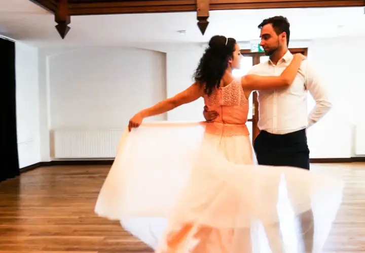Para tańczy walca wiedeńskiego. Ona w zwiewnej, brzoskwiniowej sukni, on w eleganckiej koszuli.