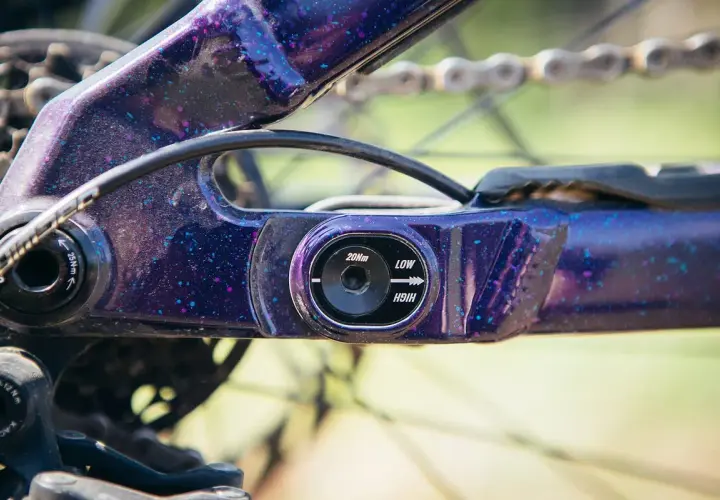 Close-up of a purple speckled flip chip mtb frame, showing adjustment settings for geometry.