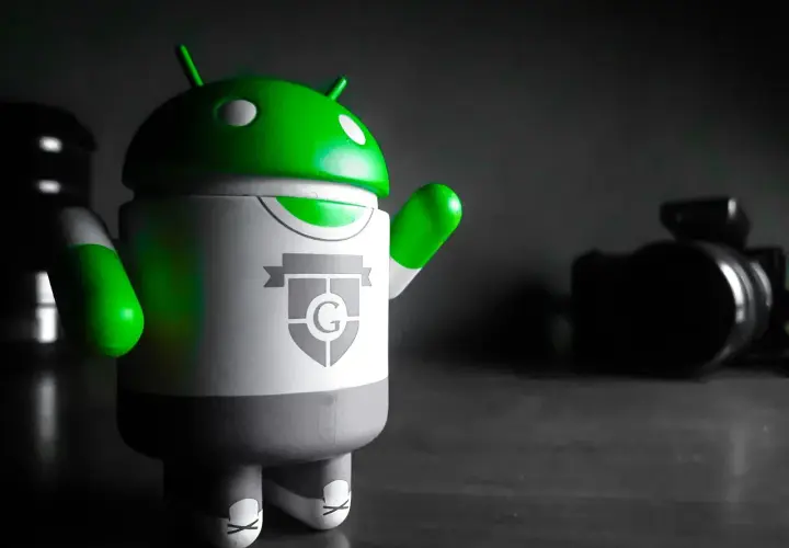 Zielony android na biurku, gotowy do pracy na PC.