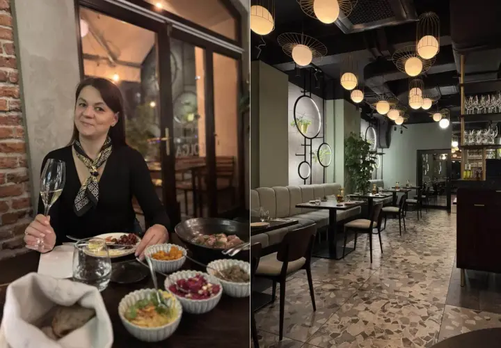 Kobieta z kieliszkiem wina w jednej z **ciekawych restauracji okolic Krakowa**. Wnętrze lokalu z nowoczesnym designem i eleganckimi lampami.