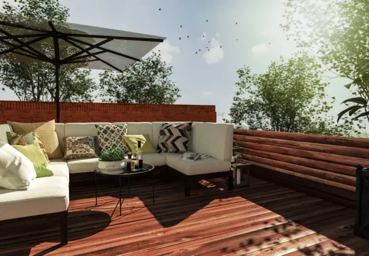 Aménagement toit terrasse avec canapé, parasol et vue sur la verdure. Un projet qui demande une autorisation.