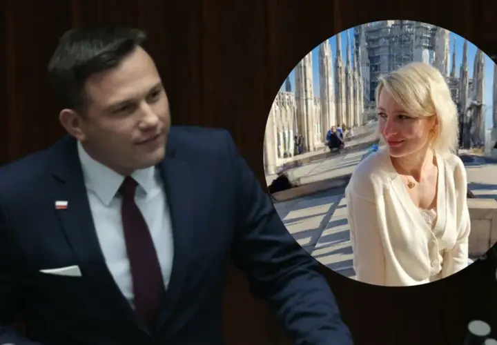 Sławomir Mentzen w garniturze i jego żona uśmiechają się na tle katedry.