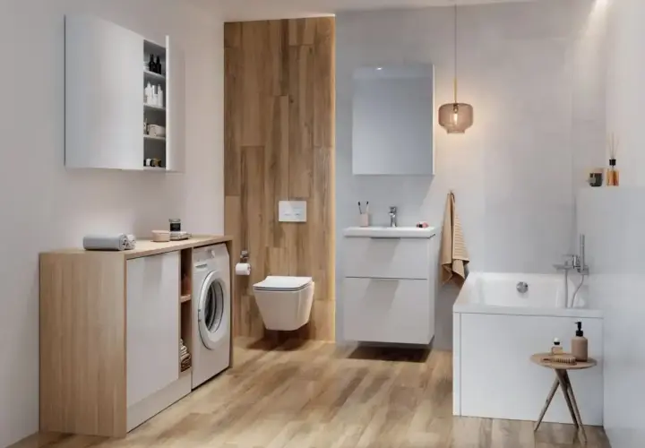 Nowoczesna łazienka z pralką, wanną i podwieszanym WC. Widoczny z tyłu złącze WC harmonijkowe.