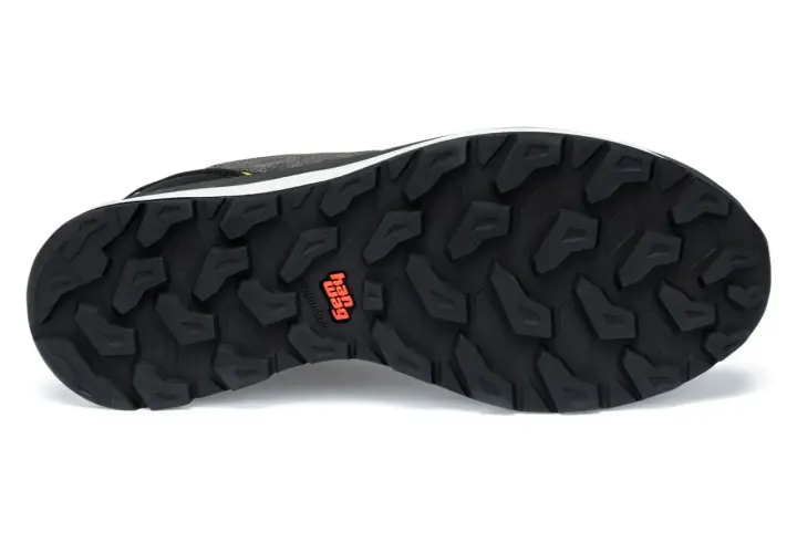 The black outsoles of a hiking shoe feature a deep, aggressive tread pattern for maximum grip. The "Hag" logo is visible in orange.