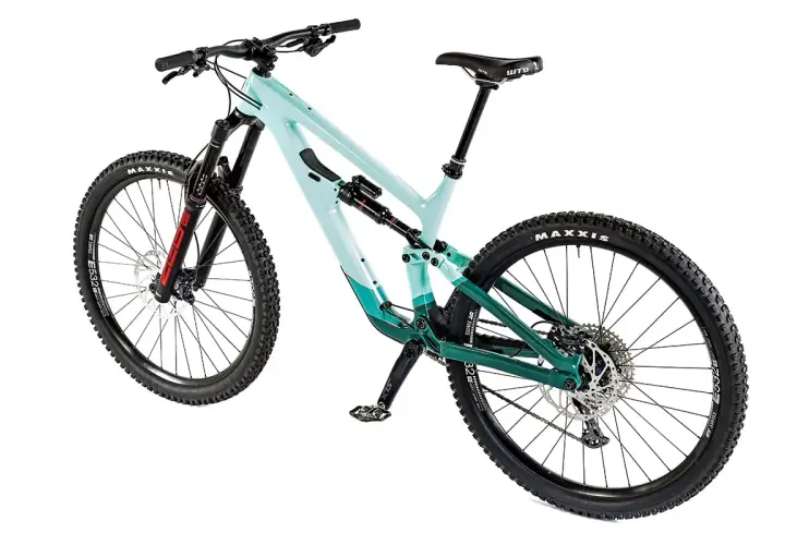 A teal and green full-suspension mountain bike, possibly a Salsa Cassidy, with Maxxis tires and a WTB saddle, ready for any trail.