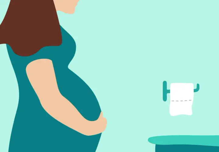 Femme enceinte tenant son ventre, près de toilettes avec papier. Une situation courante pour une femme enceinte qui cherche un laxatif doux.