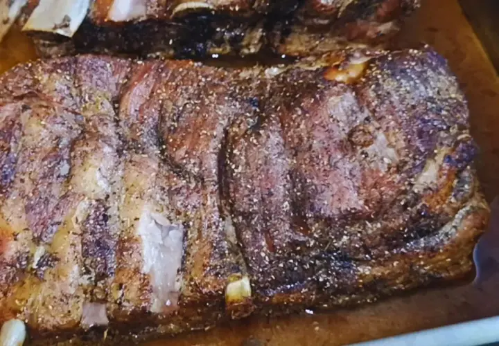 Pyszne żeberka pieczone w piekarniku w naczyniu, przyprawione i rumiane.