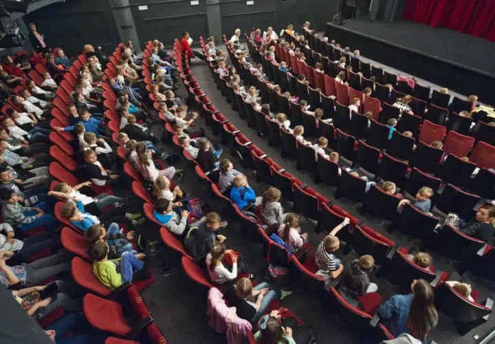 Widownia pełna dzieci i młodzieży, gotowa na spektakl w Bałtyckim Teatrze Dramatycznym.
